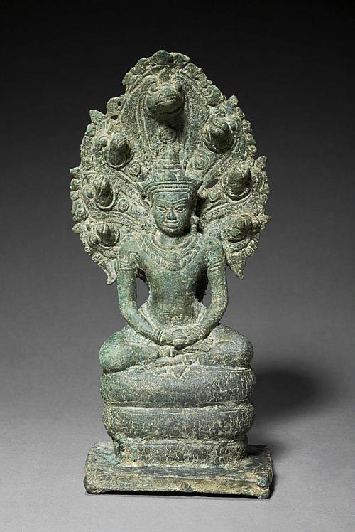 Crowned and bejeweled naga-enthroned Buddha