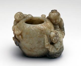 Three boys playing with large jar