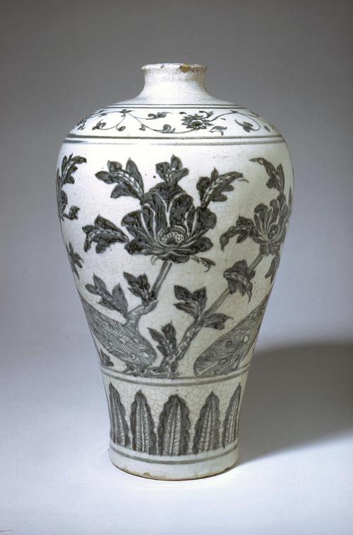 Vase with peacocks in peony garden