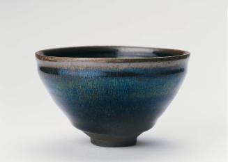 Bowl with golden-brown streaks on a black ground