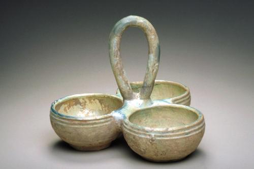 Three joined cups with a loop handle