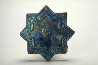 Star-shaped tile with inscriptions