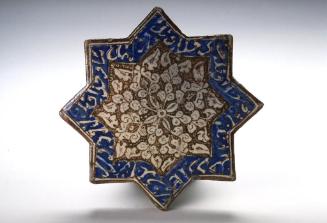 Star-shaped tile with foliate decoration and inscriptions