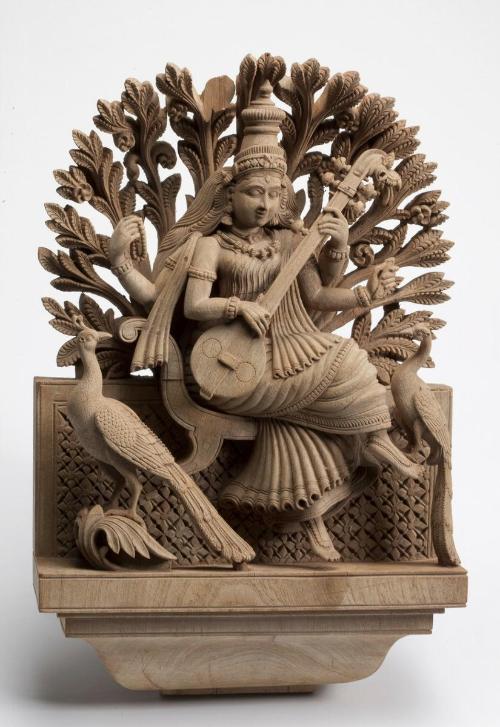 The Hindu deity Sarasvati playing the lute, with peacocks