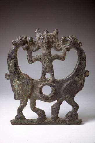 Cheek piece of a horse bit in the form of a deity between two lions