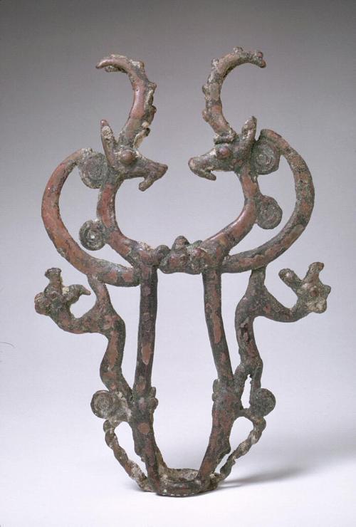 Finial in the form of confronted wild goats and rampant wild cats.