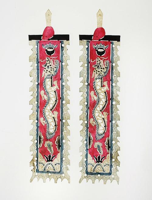 A pair of rectangular red flags depicting dragon chasing a black pearl