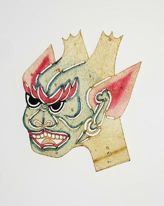 Green faced demon head with red pointed ears