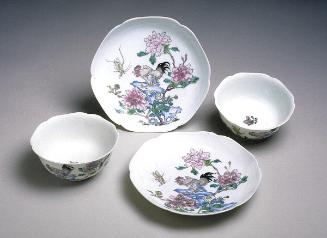 Teacup and dish depicting flowers, rock, and animals