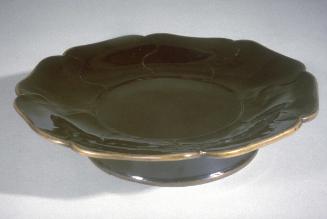 Lobed dish with metal rim and high stand