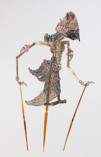 A crowned female figure with black face, perhaps Jembawati