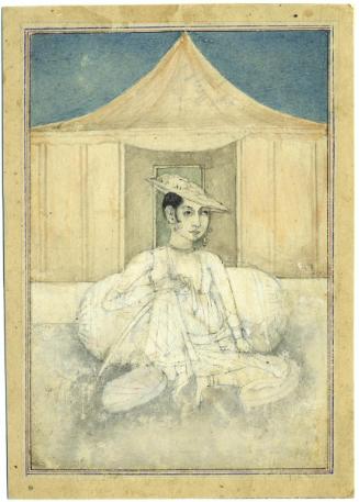 Young man seated before a tent