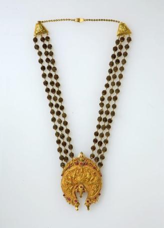 Necklace with a pendant depicting the Hindu deity Lakshmi with elephants