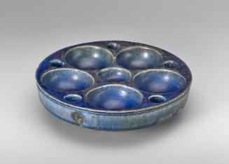 Wide bowl with multiple reservoirs in top, perhaps a dish for sweets